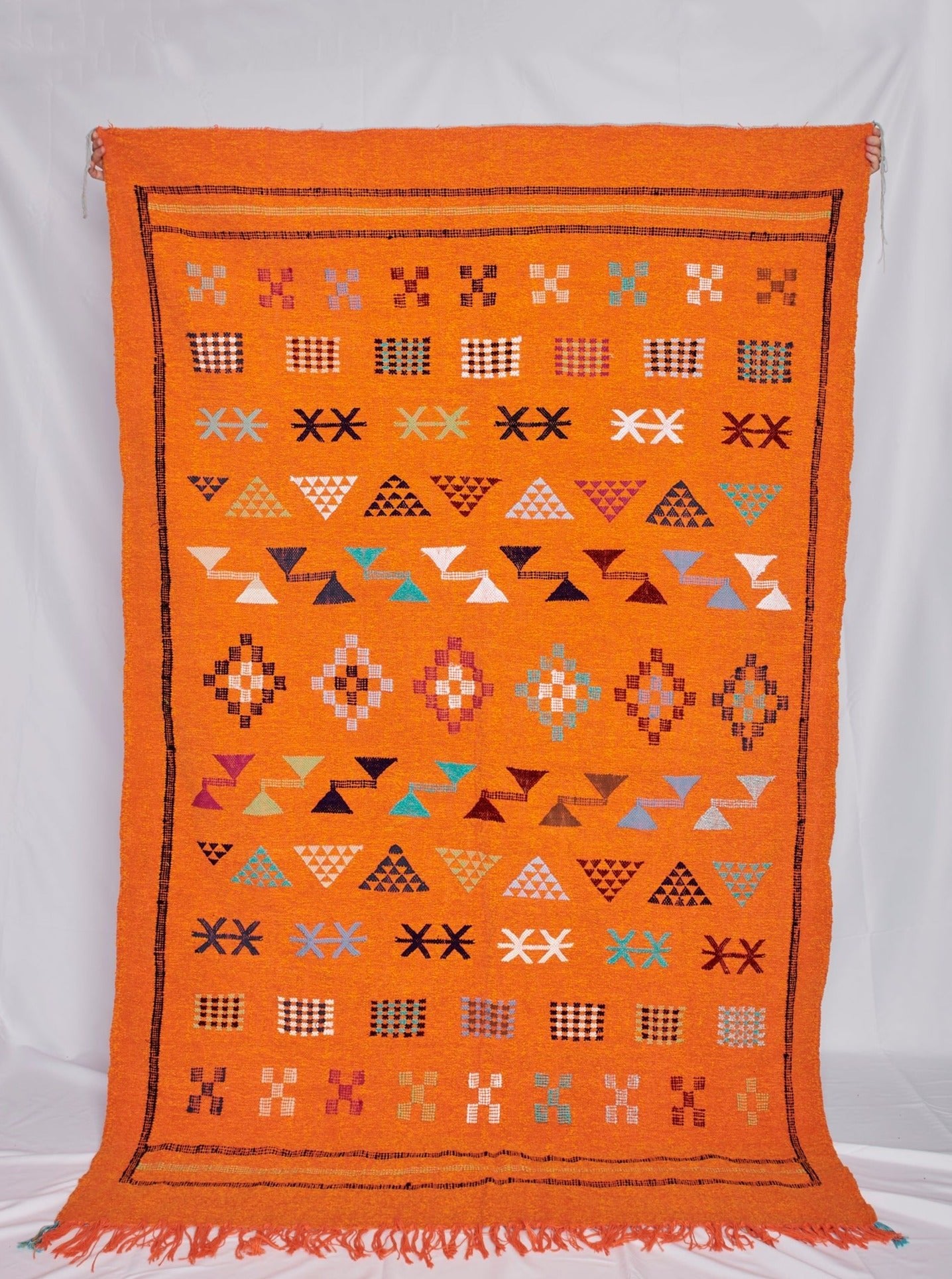 Moroccan Kilim rugs are handmade by women artisans in Morocco to be a very soft wool blend and a thin, flatweave style. Colorful, bright and vibrant colors for your living room, under dining table, or anywhere else for unique, ethnic home decor. Authentic Morocan, Morrocan style rug, bright orange. Area floor rug