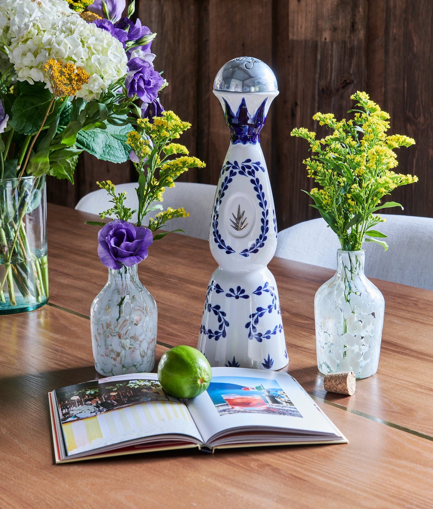 White Speckled Glass Longneck Bottle is handmade from handblown glass in Guadalajara, Mexico. Use as a flower vase or to store goods, liquor or syrups with included cork. Organic. Mexican Artisan made. Casa Azul cocktail recipe. Tabletop decor, drinkware.