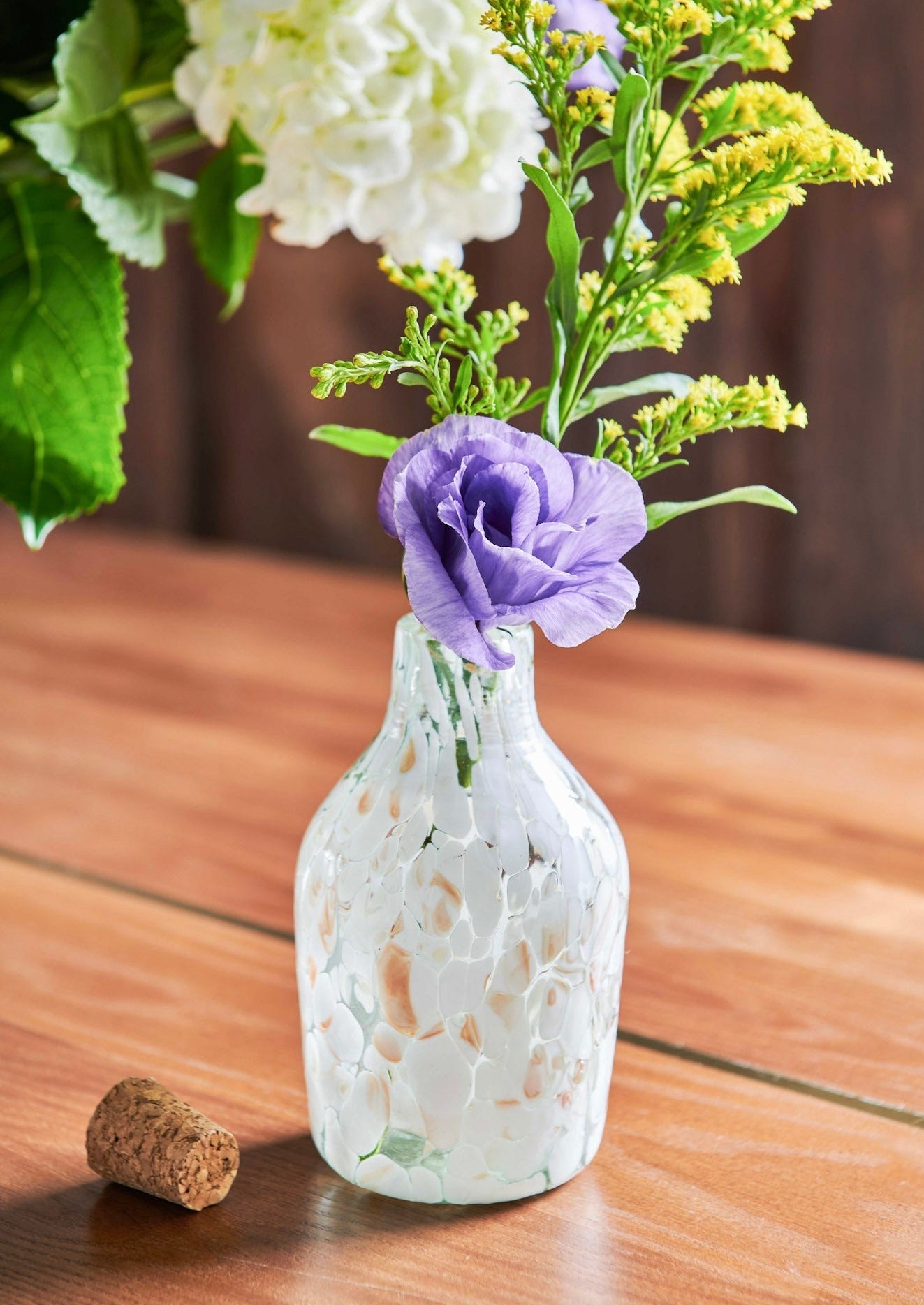 White Speckled Glass Longneck Bottle is handmade from handblown glass in Guadalajara, Mexico. Use as a flower vase or to store goods, liquor or syrups with included cork. Organic. Mexican Artisan made.