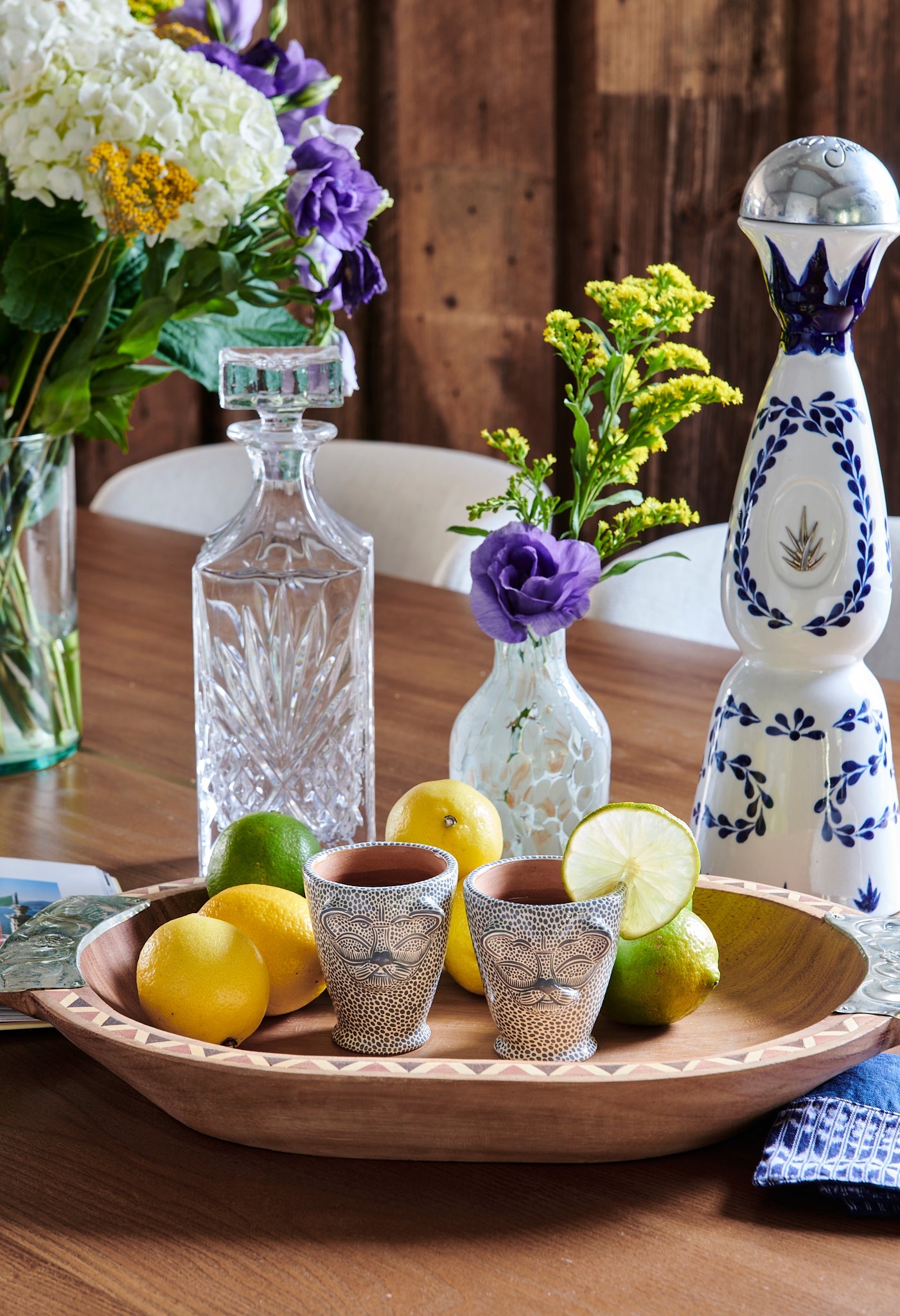 Small cup is a unique jaguar animal head shape that is hand-painted with all over dotted pattern. Made from food safe, natural clay and hand-painted with water based acrylic paint in Mexico. Use as a sipping cup, shot glass or bud vase. Drinkware, Casa Azul, cocktail set up.