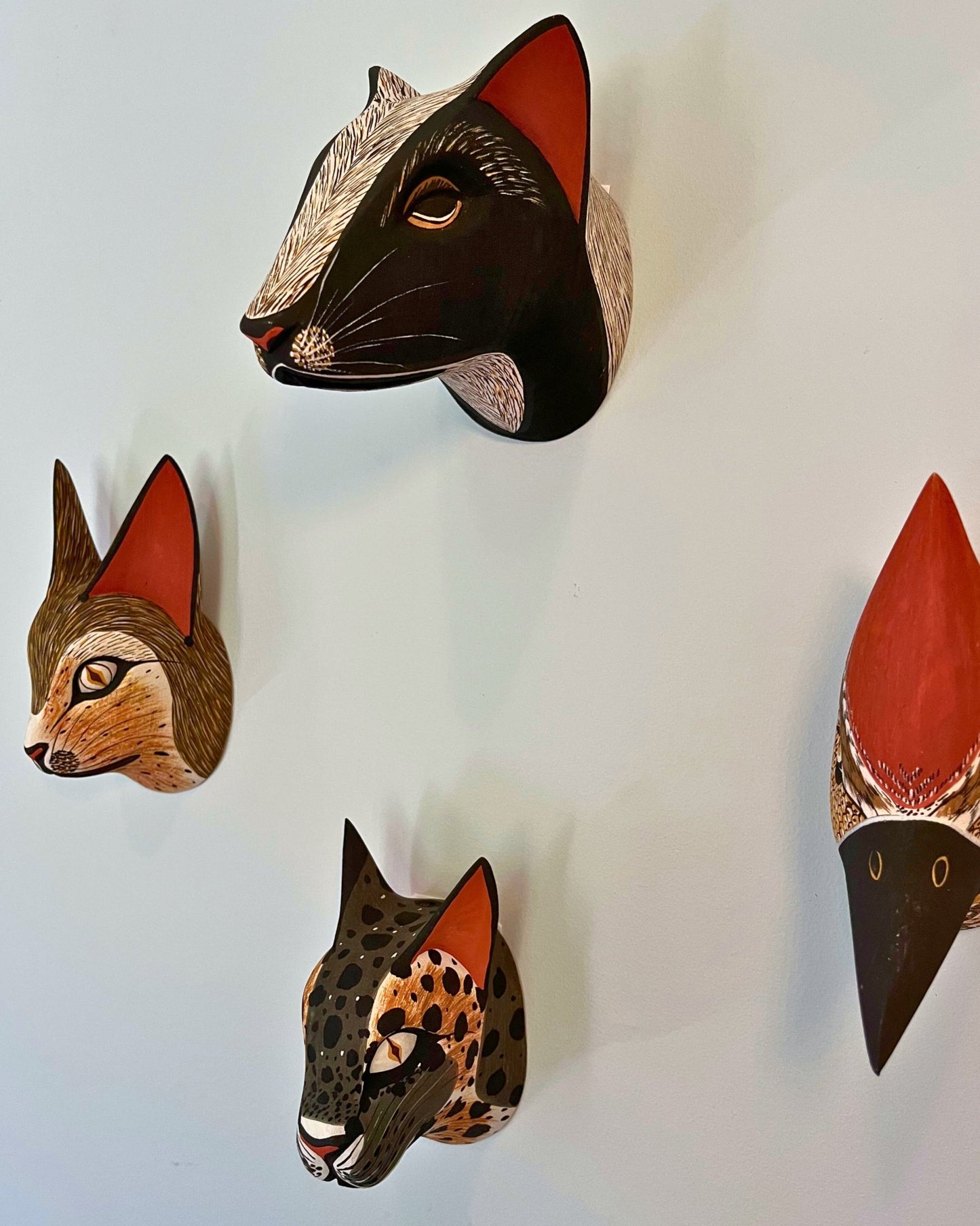Handmade, hand carved wood, hand painted wooden animal head masks, artifact. One-of-a-kind, unique wall decor, sit-about home décor. Artisan made Chané masks in Argentina. Skunk, Fox, Jaguar