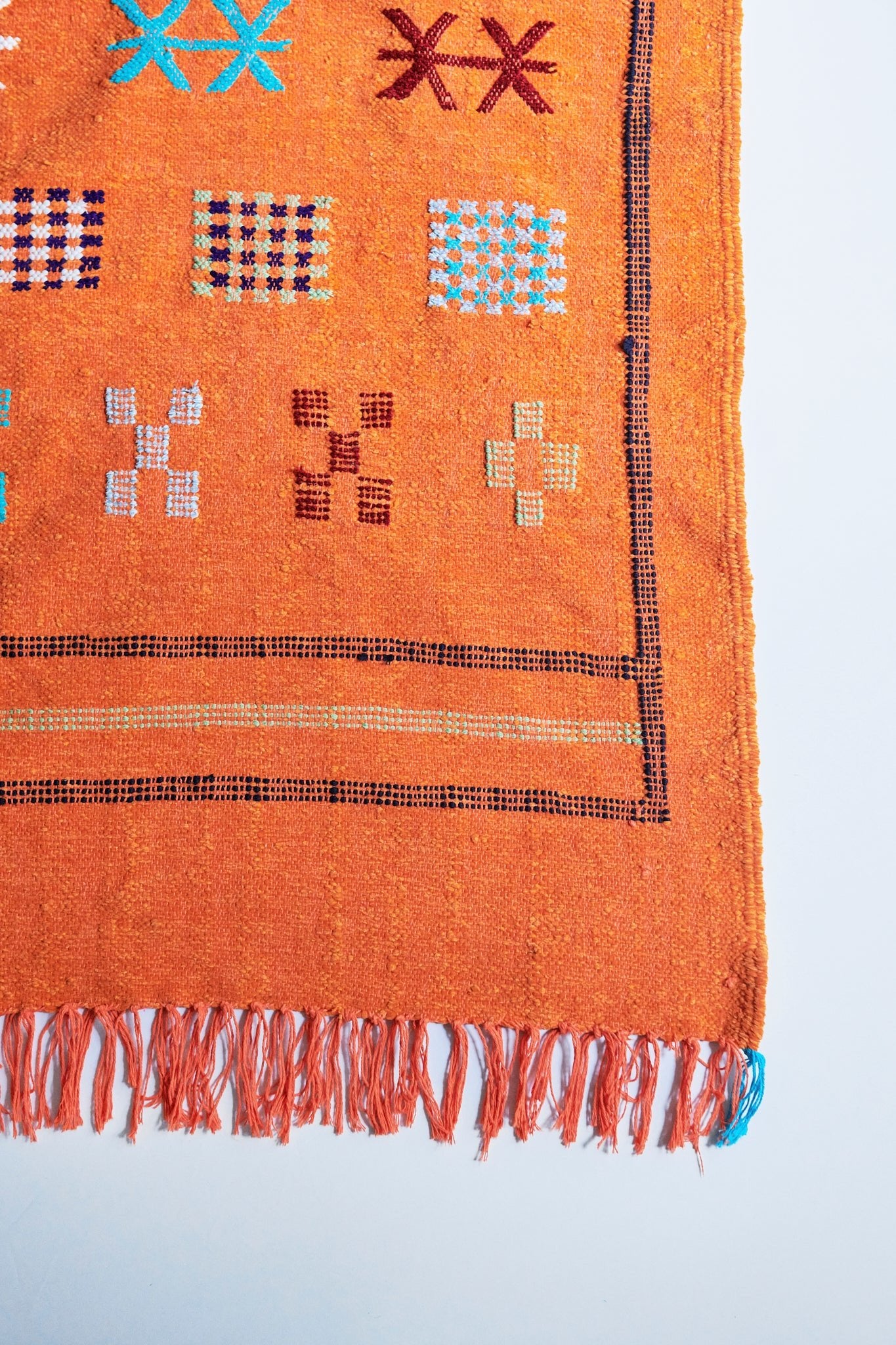 Moroccan Kilim rugs are handmade by women artisans in Morocco to be a very soft wool blend and a thin, flatweave style. Colorful, bright and vibrant colors for your living room, under dining table, or anywhere else for unique, ethnic home decor. Authentic Morocan, Morrocan style rug, bright orange. Area floor rug