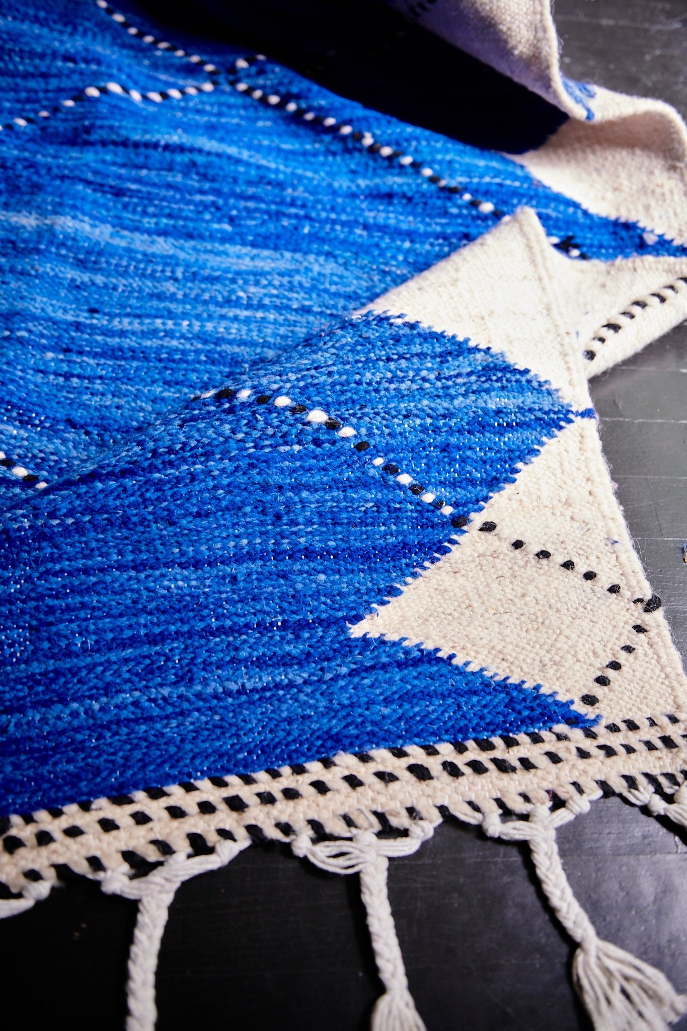 Oversized Moroccan Berber rug is uniquely and sustainably handmade by women artisans near Fes, Morocco out of a wool and cotton blend. Blue, Cream and Black Geometric X design is an authentic Moroccan style made in colorful, bright and vibrant colors for your living room, under dining table, or anywhere else for unique, ethnic home decor. Area floor rug